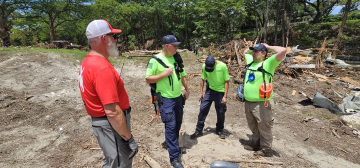 Team members in high-visibility vests plan the day's work